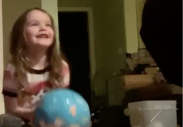Girl with blue ball repeating letter sounds
